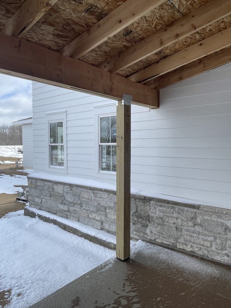 building a wraparound porch and laying the stone